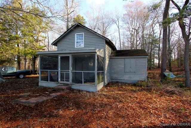 back of house featuring a sunroom