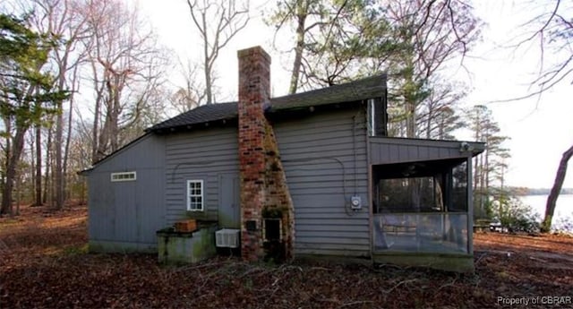 back of property with a sunroom