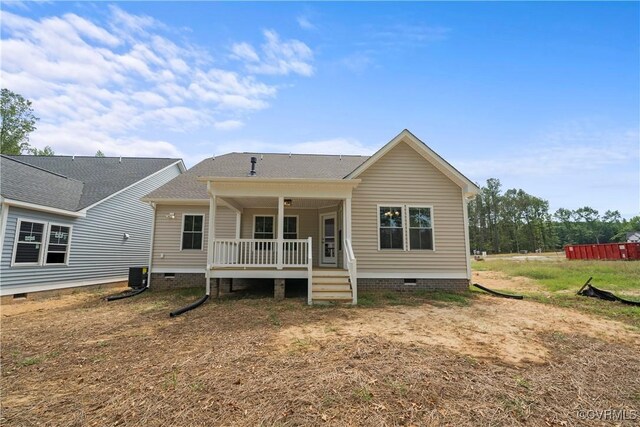 back of property with a porch