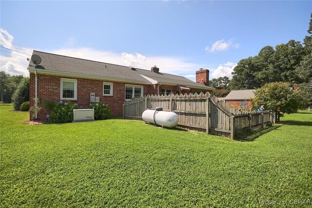 rear view of house with a lawn