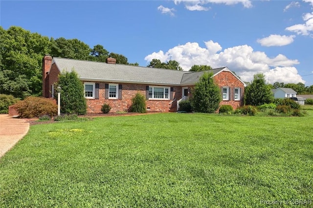 single story home with crawl space, a chimney, brick siding, and a front yard