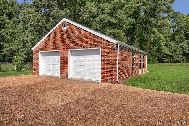 garage featuring a lawn