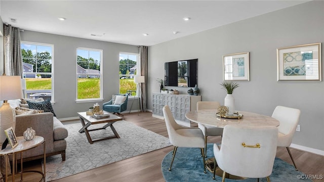 dining room with visible vents, baseboards, wood finished floors, and recessed lighting