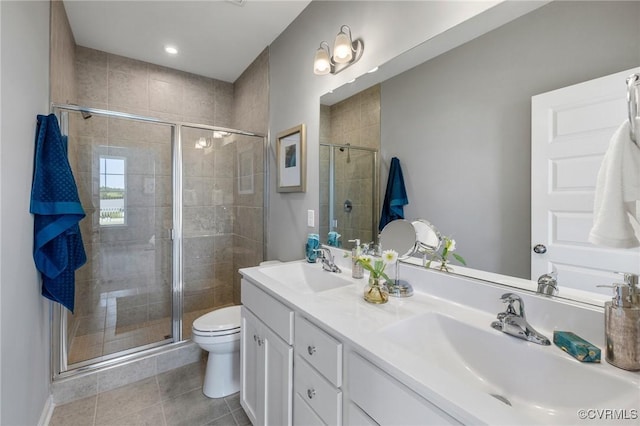 bathroom with a sink, toilet, and a shower stall