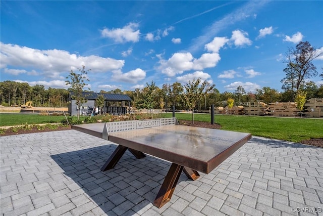 view of community featuring a lawn and a patio area