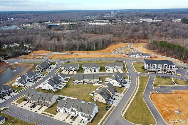 birds eye view of property featuring a residential view, a water view, and a forest view