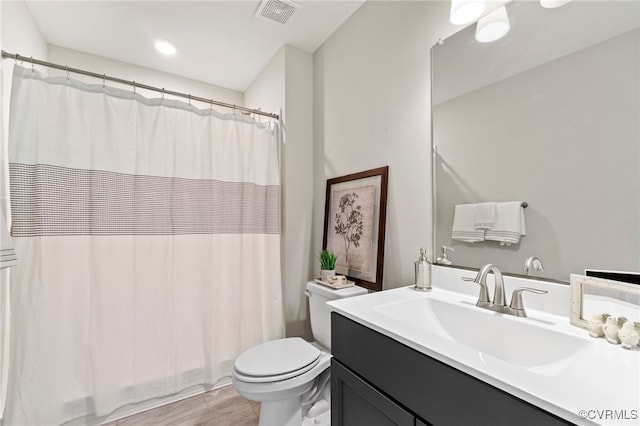 bathroom with a shower with shower curtain, visible vents, toilet, and vanity