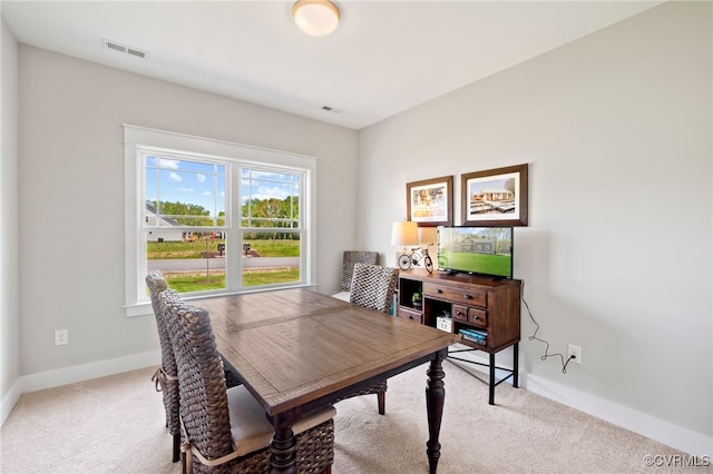 carpeted home office featuring visible vents and baseboards