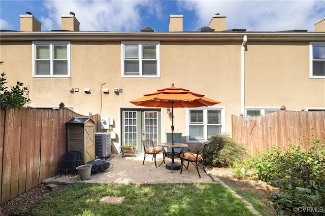 back of property featuring central AC unit and a patio