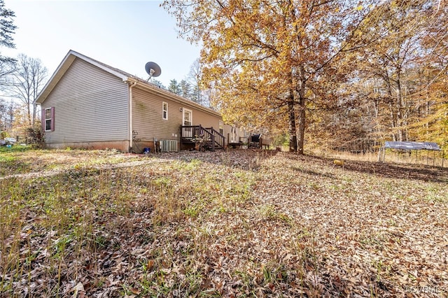 exterior space featuring central AC unit and a deck