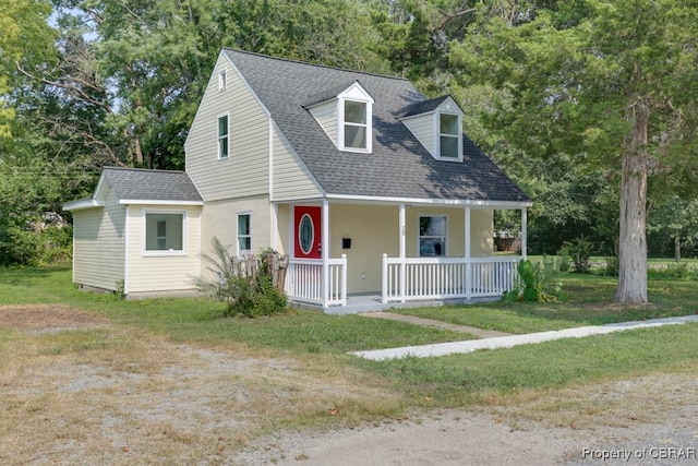 cape cod house with covered porch and a front lawn