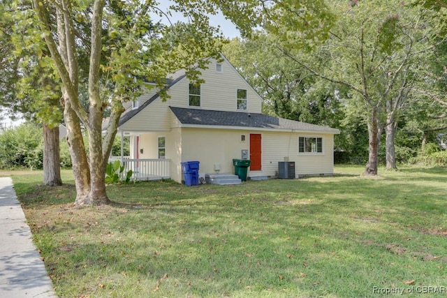 exterior space with central AC unit and a yard