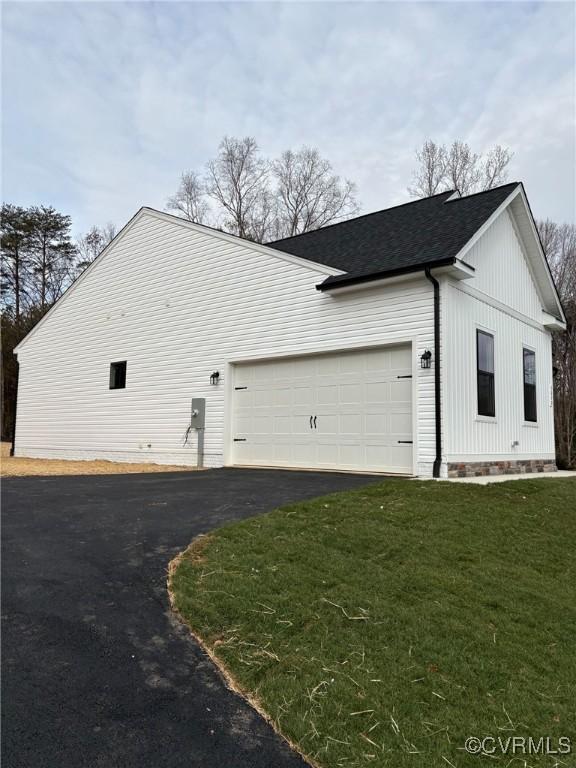 view of side of property with a garage and a yard