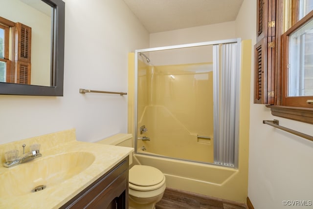 full bathroom featuring a textured ceiling, vanity, wood-type flooring, bathing tub / shower combination, and toilet