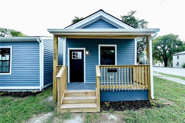 bungalow-style home featuring a porch and a front yard