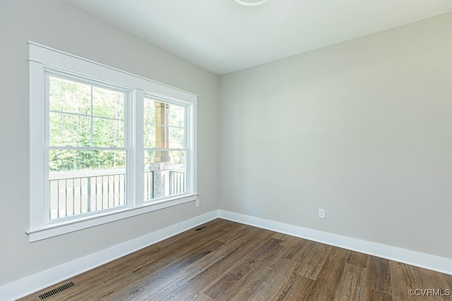 spare room with dark hardwood / wood-style flooring