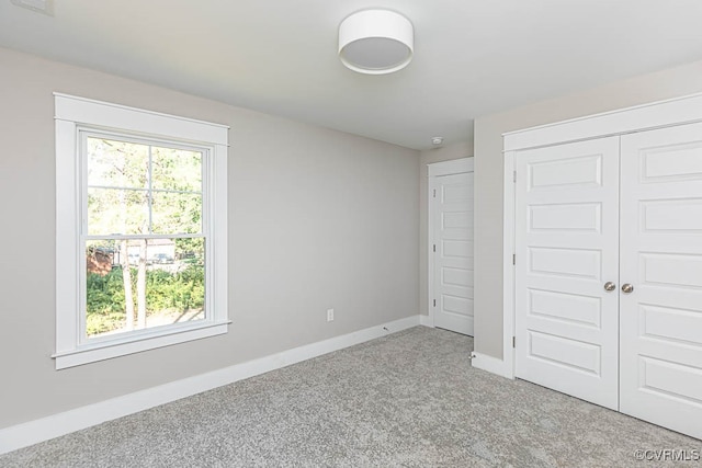 unfurnished bedroom featuring carpet floors and a closet