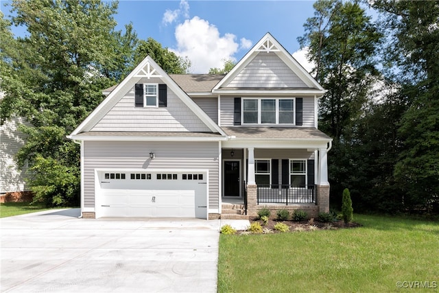 craftsman inspired home featuring a front yard, a garage, and a porch