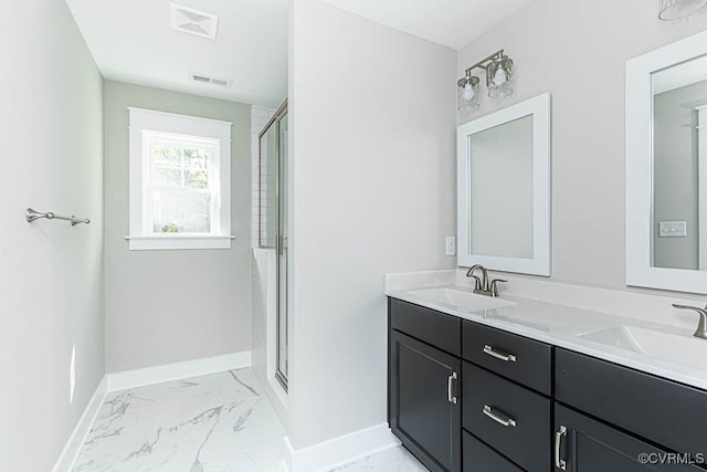 bathroom featuring a shower with door and vanity