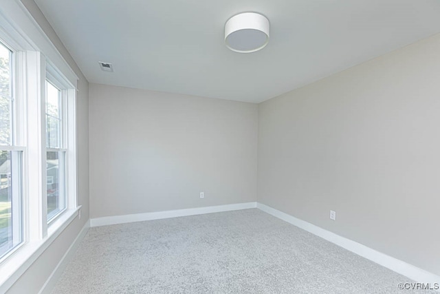 carpeted empty room featuring a healthy amount of sunlight