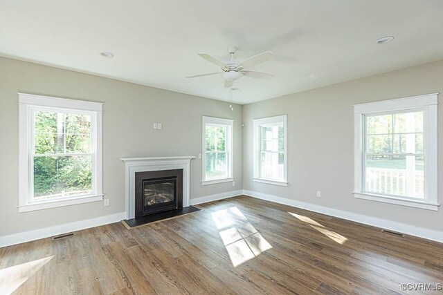 unfurnished living room featuring hardwood / wood-style floors and ceiling fan