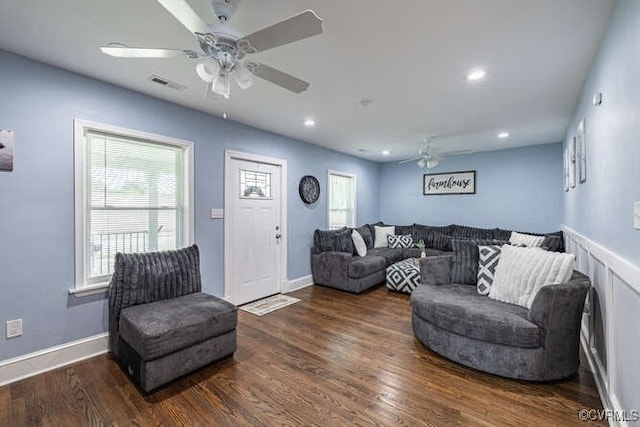 living room with ceiling fan and dark hardwood / wood-style flooring