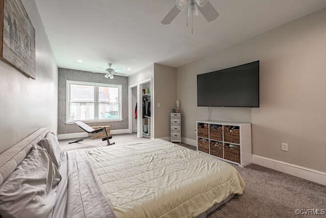 bedroom with ceiling fan, a closet, carpet, and a spacious closet