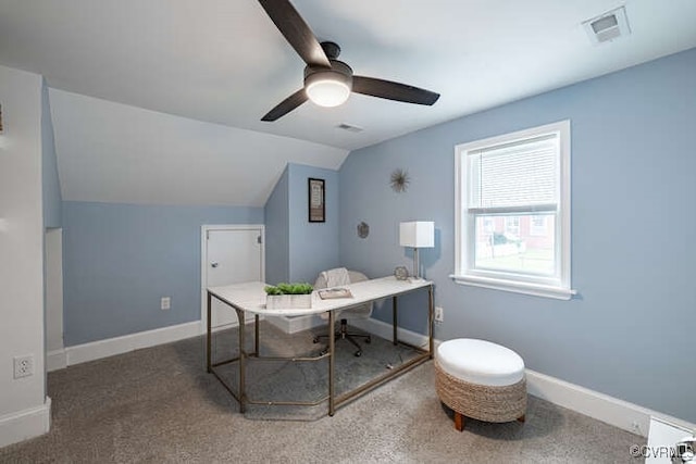 office space featuring dark carpet, lofted ceiling, and ceiling fan