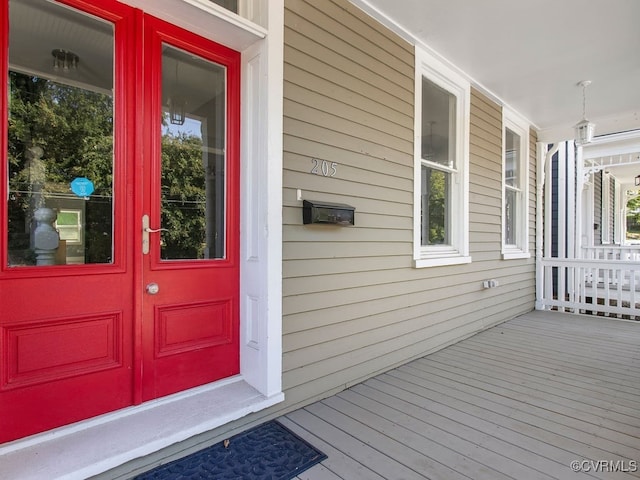 view of exterior entry featuring a porch