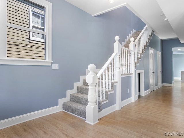 stairs with hardwood / wood-style floors