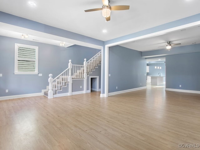 unfurnished living room featuring light hardwood / wood-style flooring and ceiling fan