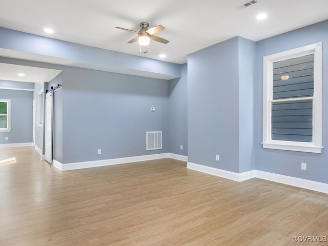 unfurnished room with ceiling fan and light wood-type flooring