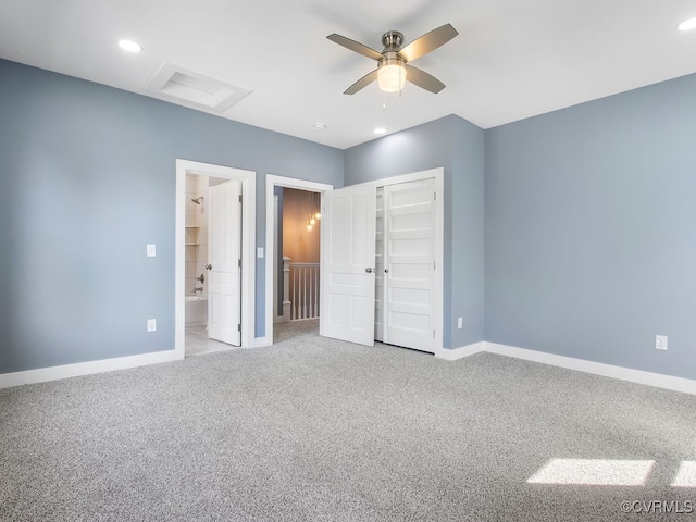 unfurnished bedroom featuring a closet, light colored carpet, connected bathroom, and ceiling fan