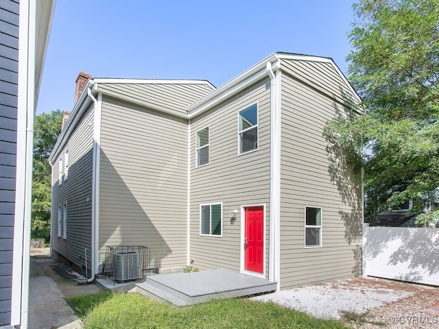 rear view of house with cooling unit and a patio area