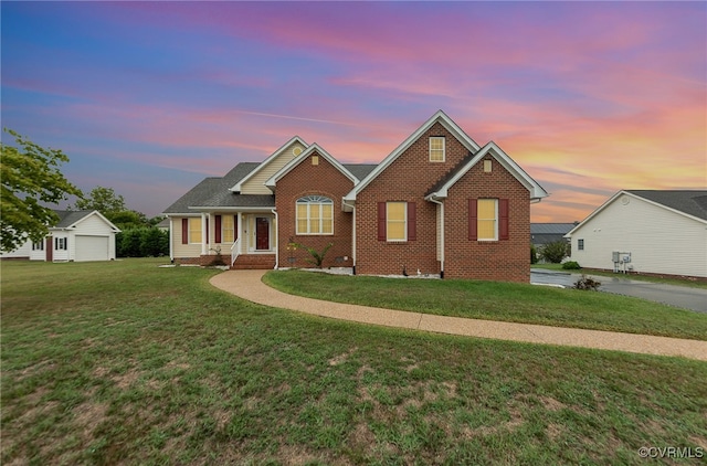 view of front facade featuring a lawn, a garage, and an outdoor structure