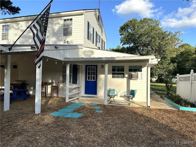 view of front of house featuring fence