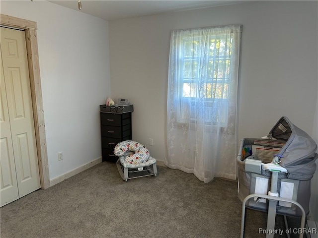 carpeted bedroom featuring baseboards