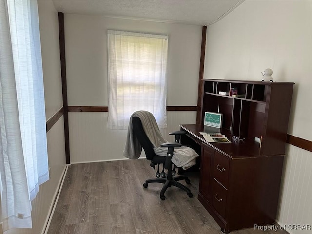 office featuring wainscoting, a textured ceiling, and wood finished floors