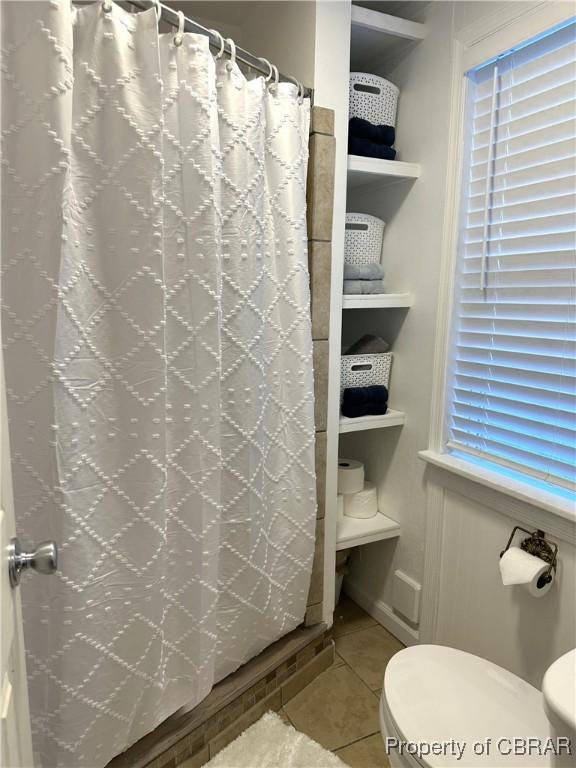 full bath with tile patterned flooring, toilet, and a shower with shower curtain