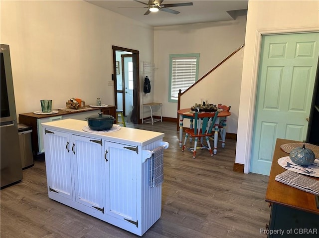 kitchen with a kitchen island, baseboards, dark wood finished floors, smart refrigerator, and a ceiling fan