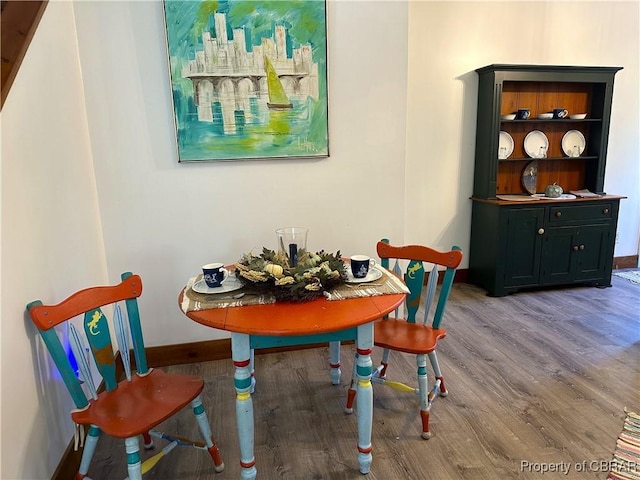 dining room with wood finished floors and baseboards