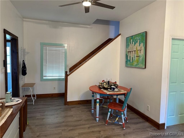 dining space with baseboards, wood finished floors, and a ceiling fan