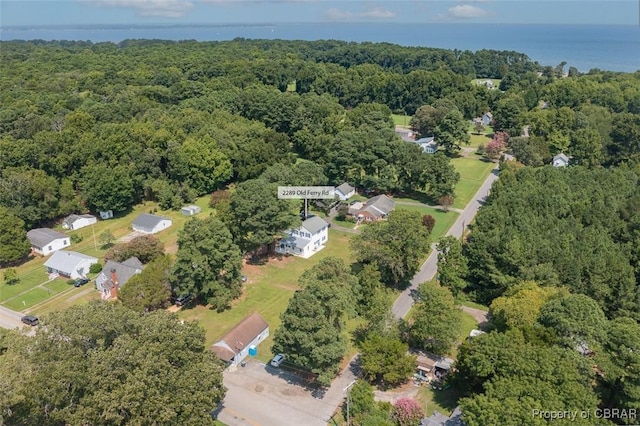 aerial view with a wooded view and a water view