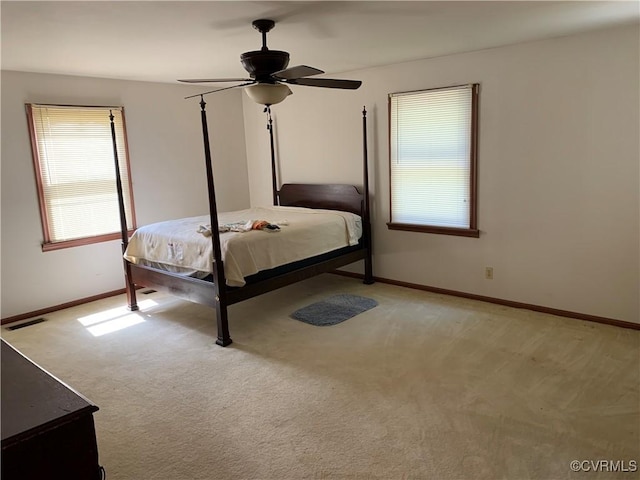 unfurnished bedroom with light carpet, visible vents, ceiling fan, and baseboards