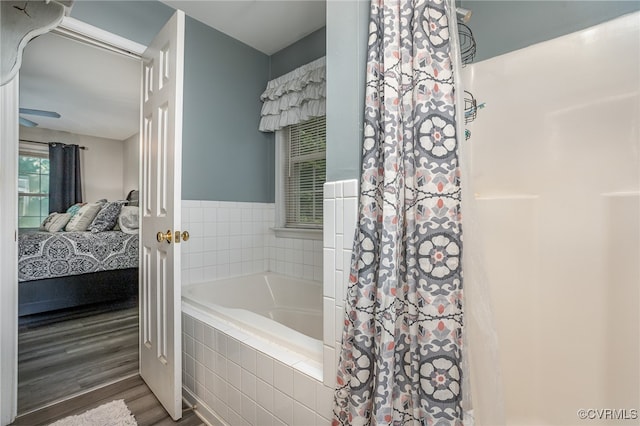 bathroom with independent shower and bath and wood-type flooring