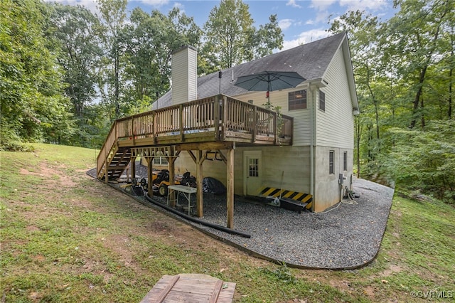 rear view of property featuring a wooden deck