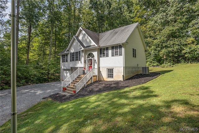 split foyer home featuring central AC unit, a garage, and a front lawn