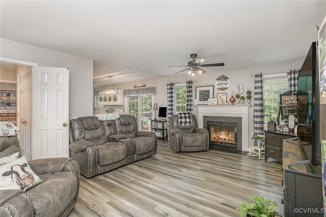 living room with light hardwood / wood-style flooring and ceiling fan