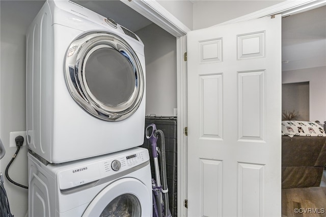 washroom featuring stacked washer / drying machine