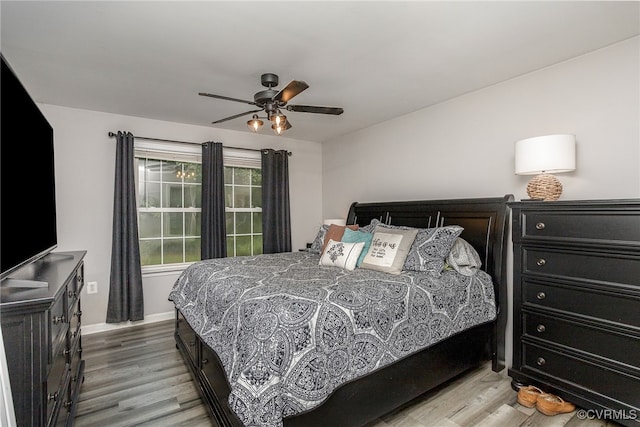 bedroom with light wood-type flooring and ceiling fan